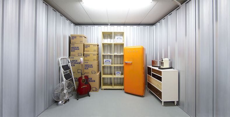 100 sq ft personal storage unit showcasing organised household items such as furniture, boxes, and appliances, providing a reliable space for temporary or long-term storage needs.