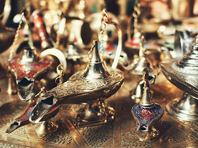 selective focus photo of gold-colored oil lamps