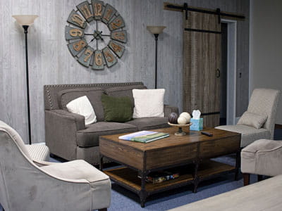 two white throw pillows on top of grey sofa