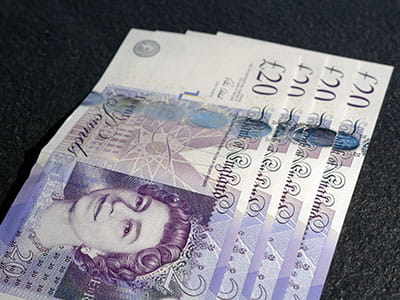 four 20 pound sterling notes