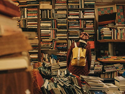 person carrying backpack inside library