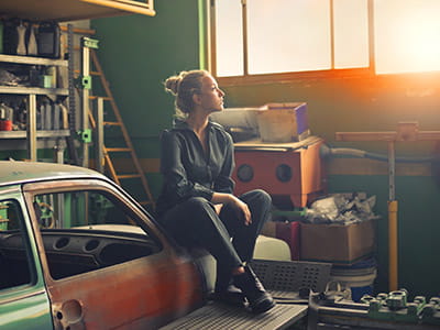 woman sitting on orange vehicle